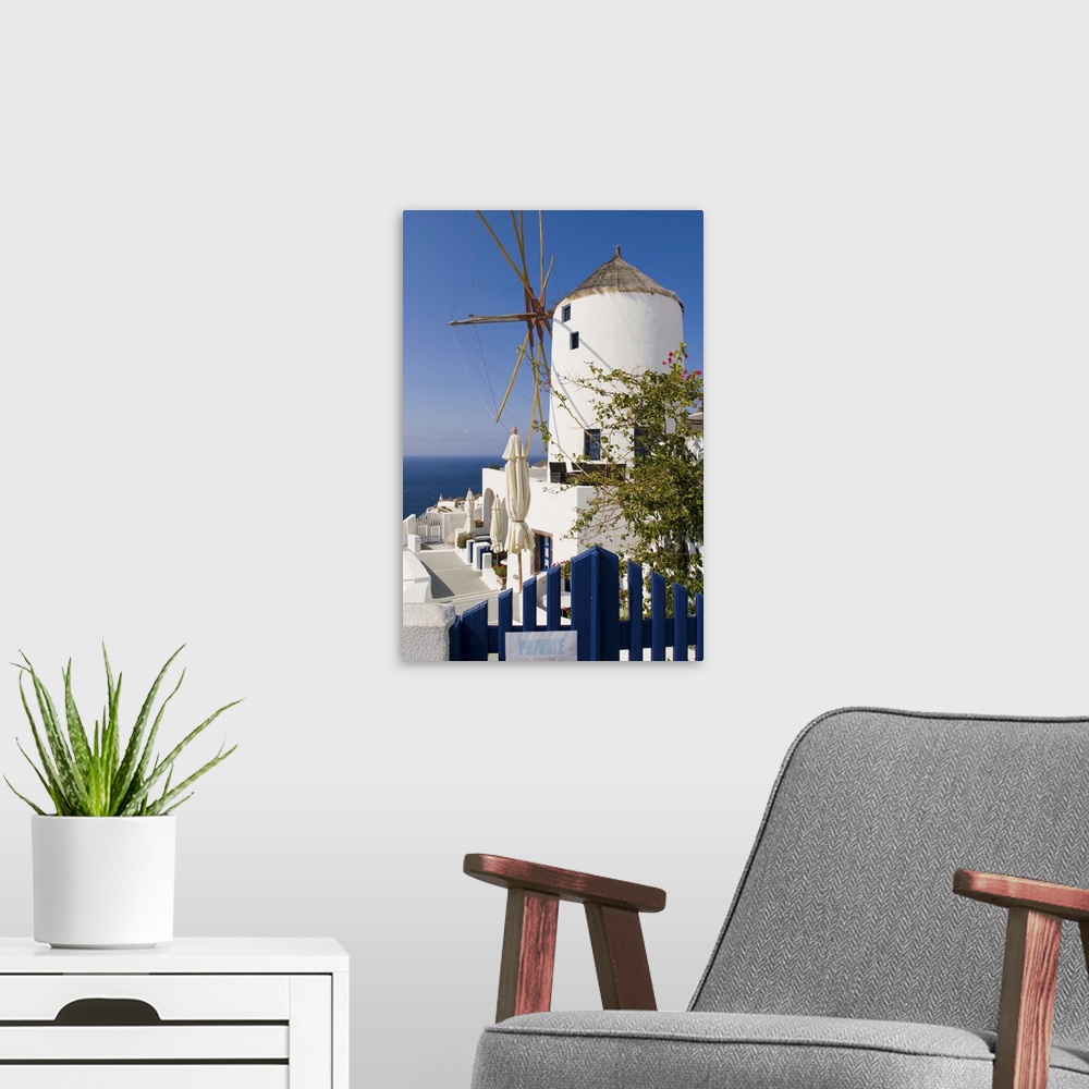 A modern room featuring Windmill in cliff top village of Oia, Santorini, Greece