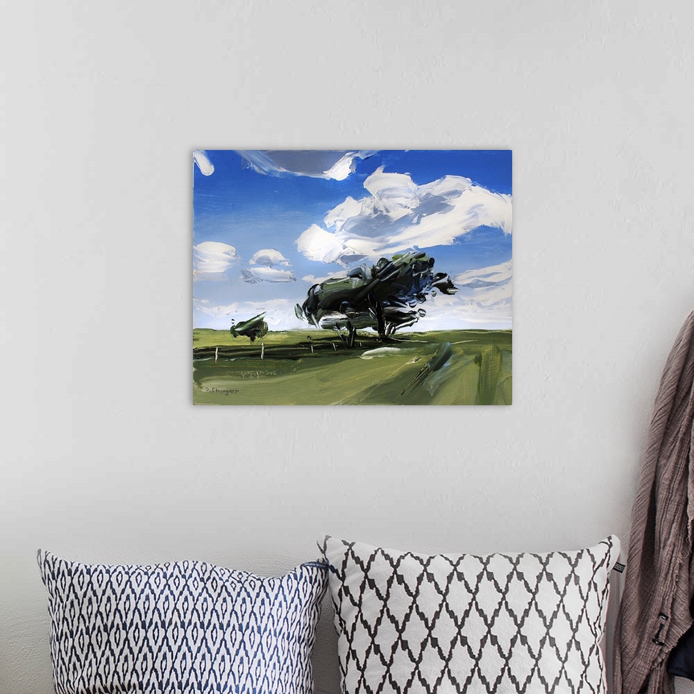 A bohemian room featuring A contemporary painting of a green field with trees under a sky filled with gray clouds.