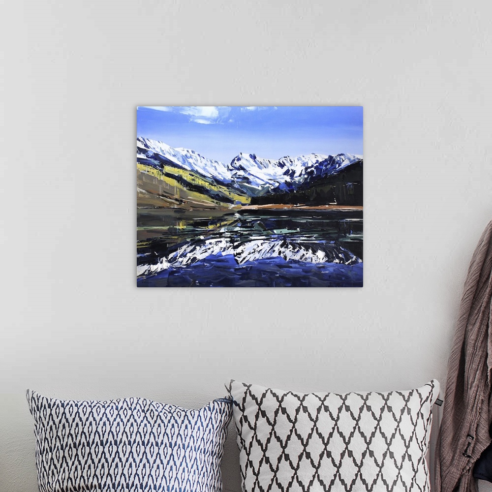 A bohemian room featuring Contemporary palette knife painting of a lake with snow covered mountains reflecting in the water.