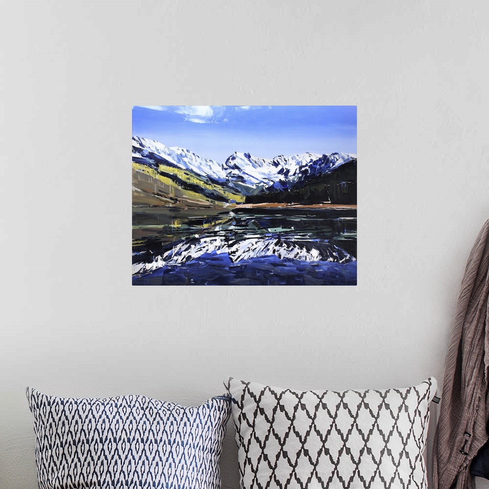 A bohemian room featuring Contemporary palette knife painting of a lake with snow covered mountains reflecting in the water.