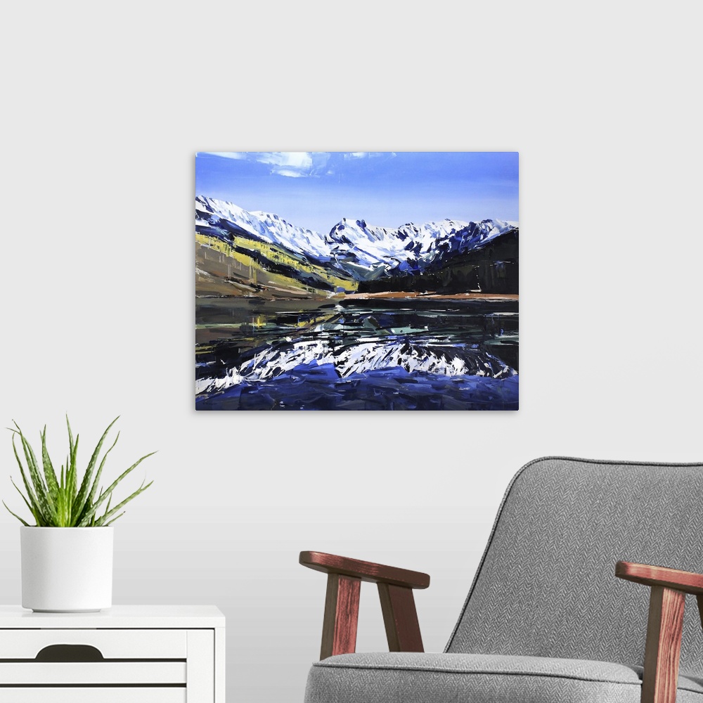 A modern room featuring Contemporary palette knife painting of a lake with snow covered mountains reflecting in the water.