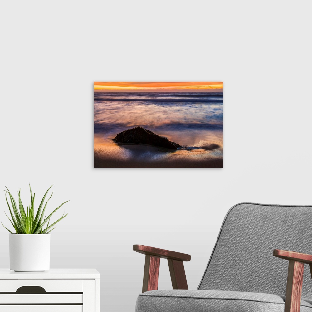 A modern room featuring Rocks & Ocean Waves at sunset along the California Coast near Carmel, California, USA.