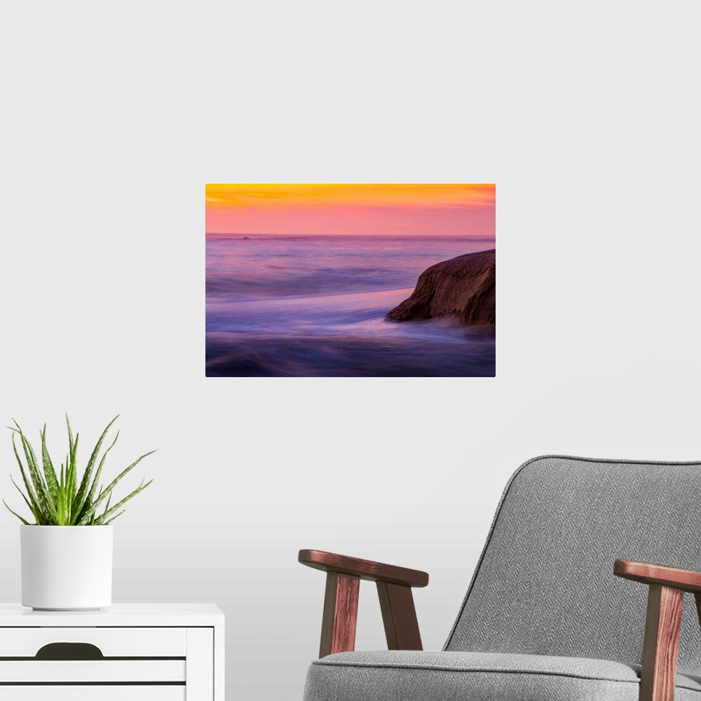 A modern room featuring Rocks & Ocean Waves at sunset along the California Coast near Carmel, California, USA.
