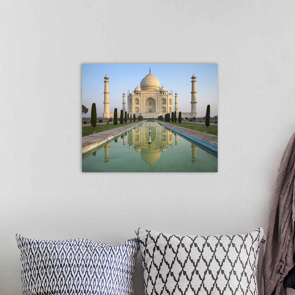 A bohemian room featuring A perspective view on Taj Mahal mausoleum with reflection in water. Agra, India.