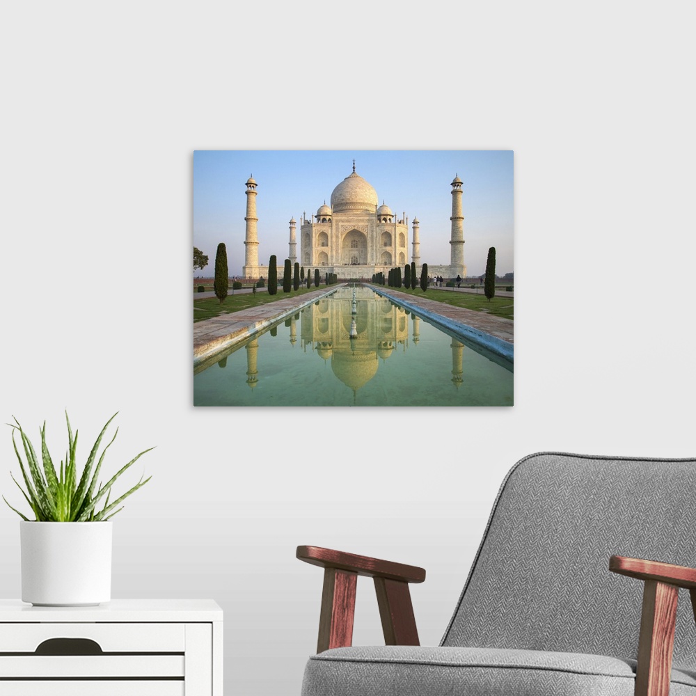 A modern room featuring A perspective view on Taj Mahal mausoleum with reflection in water. Agra, India.