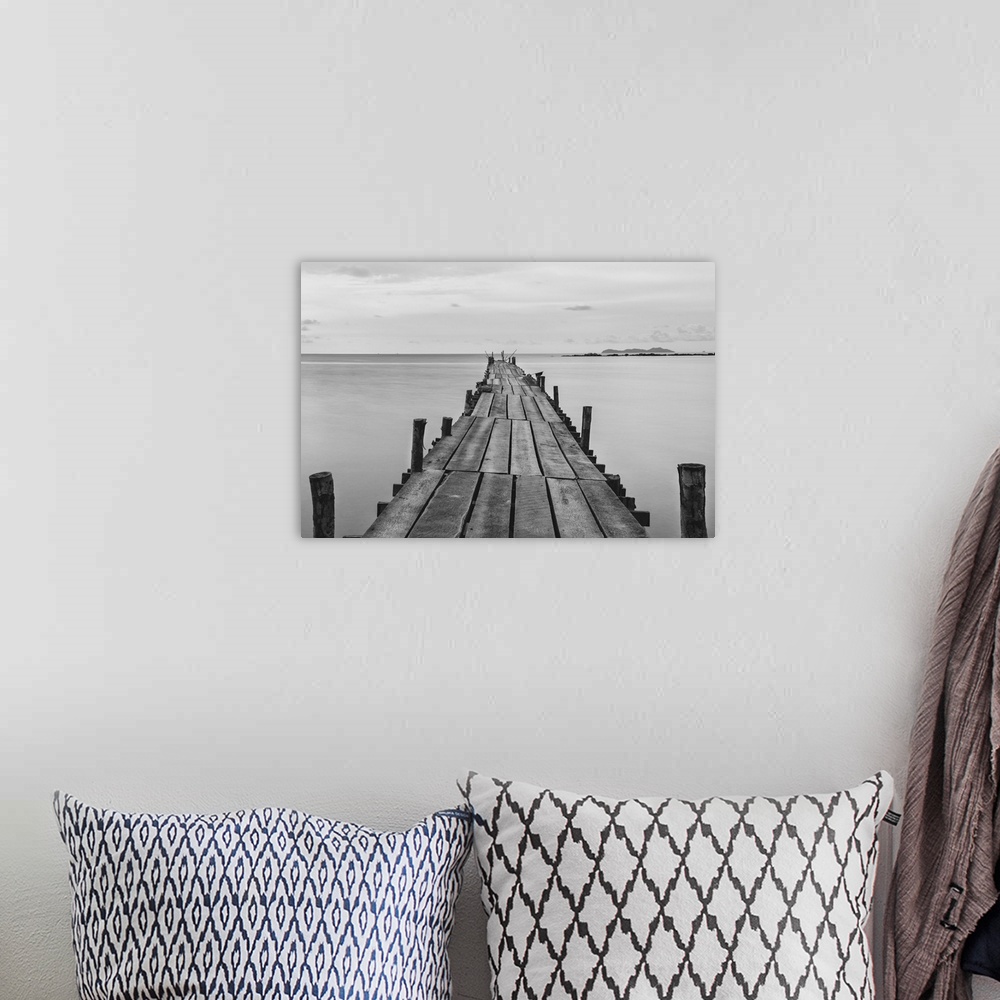 A bohemian room featuring Black and white photograph of a beach wooden pier.