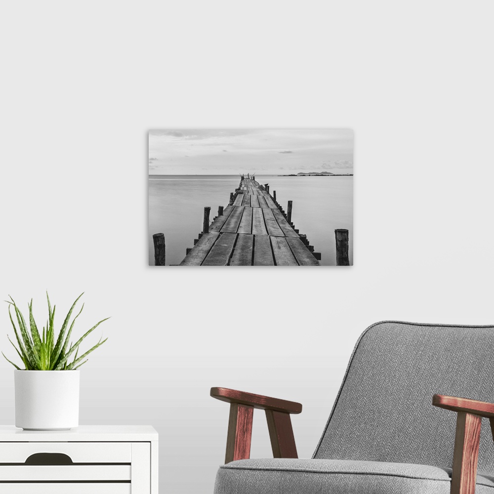 A modern room featuring Black and white photograph of a beach wooden pier.