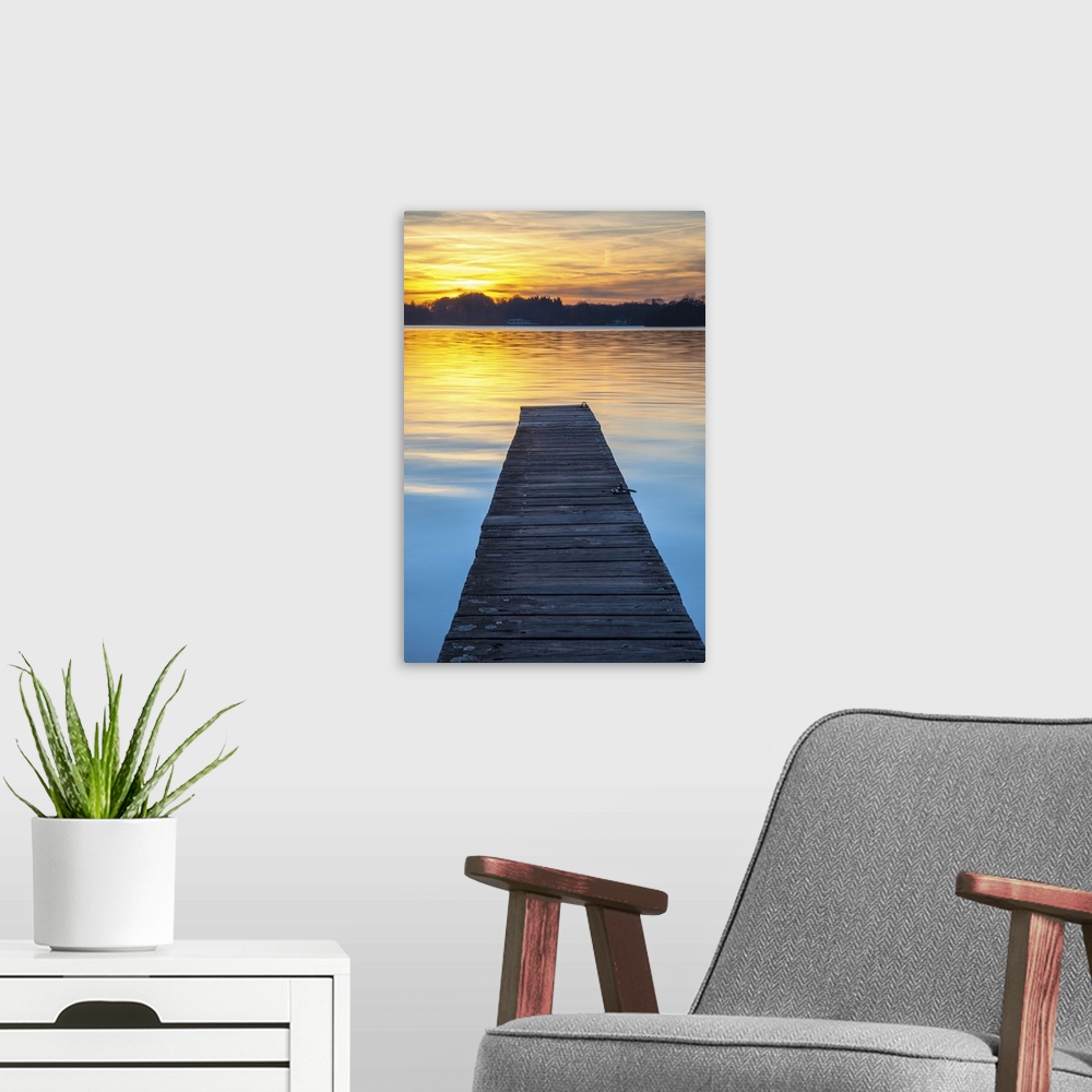 A modern room featuring Sunset over serene water of lake Paterwoldsemeer.