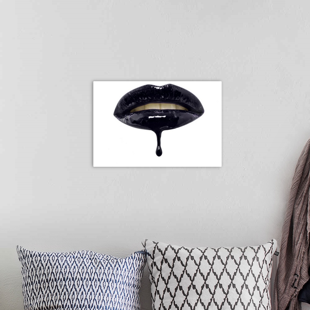A bohemian room featuring Close-up of black lip-gloss dripping from woman's lips over a white background.