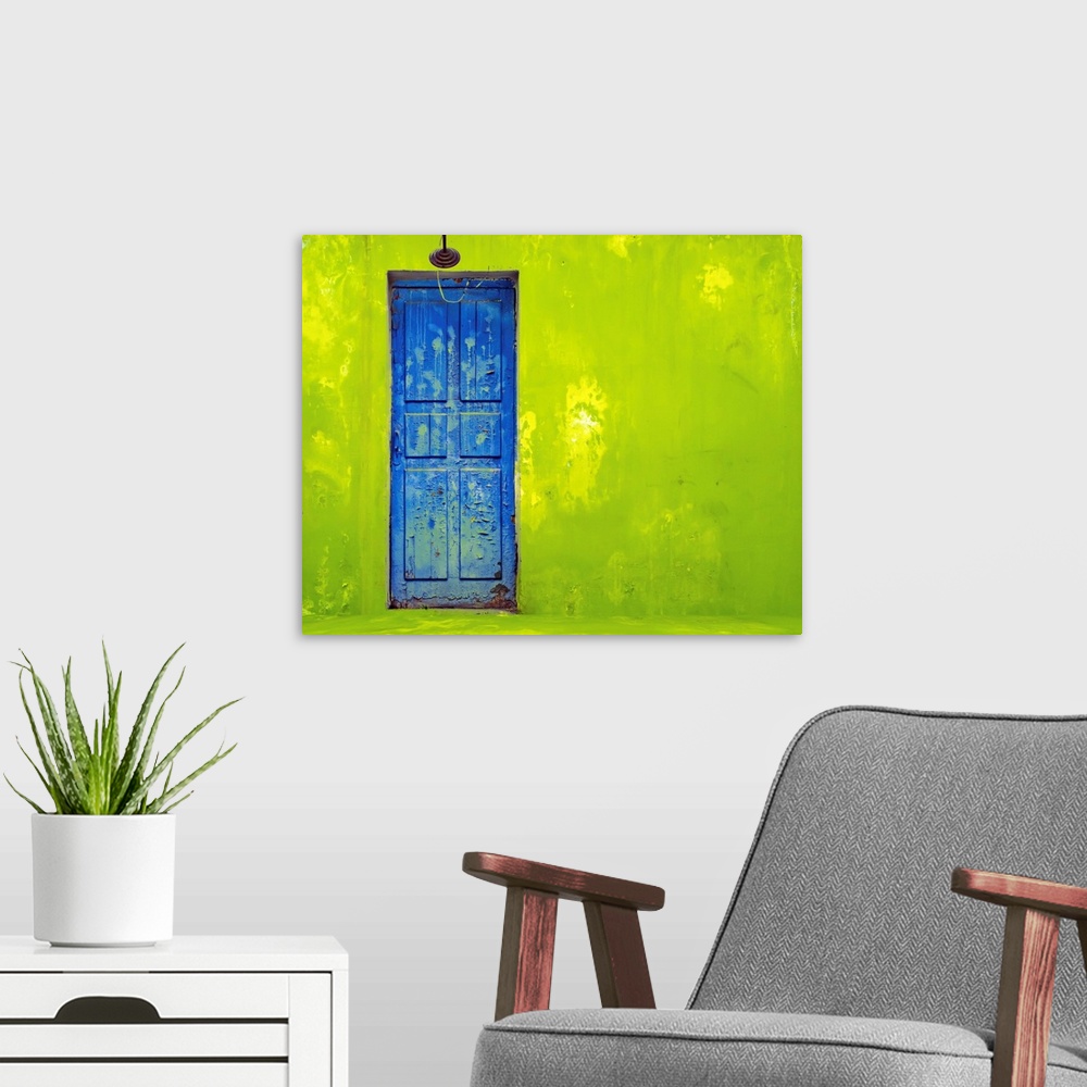 A modern room featuring Blue Door In A Shabby Green Wall