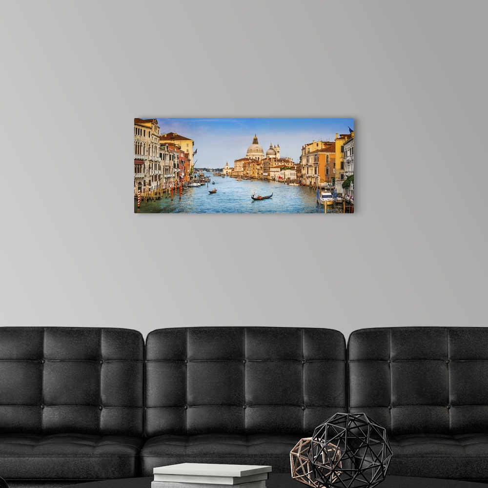 A modern room featuring Panoramic view of famous canal grande and Basilica Di Santa Maria Della salute in golden evening ...