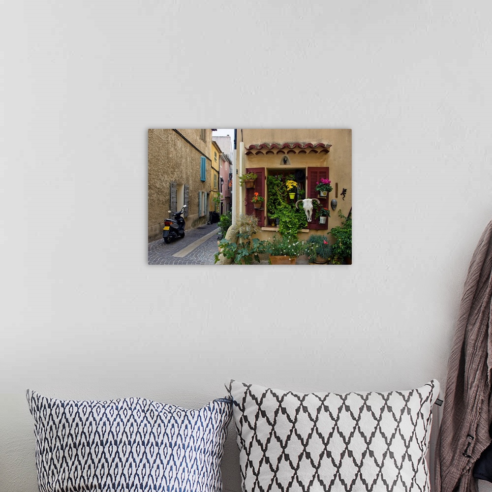 A bohemian room featuring The seaside town of cassis, old street, European town, a journey through France.
