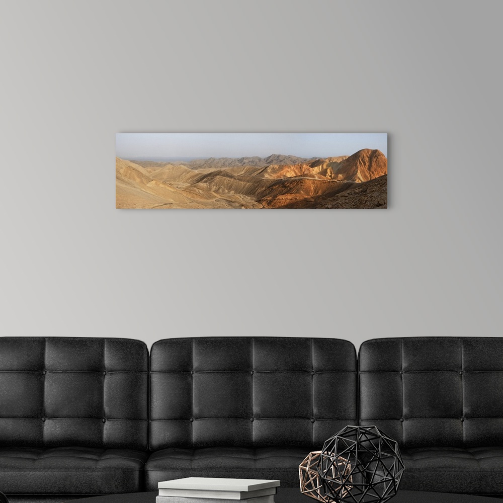 A modern room featuring Desert landscape panorama at sunset.