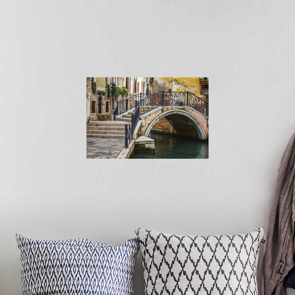 A bohemian room featuring Narrow canal among old colorful brick houses in Venice, Italy.