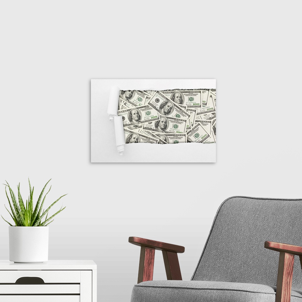 A modern room featuring Close-up of a hole in paper over American hundred dollar bills. Business background.