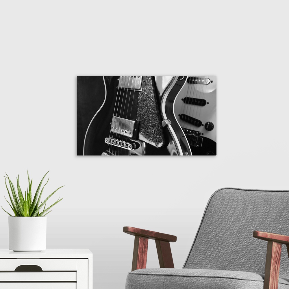 A modern room featuring Electric guitar closeup on dark background.