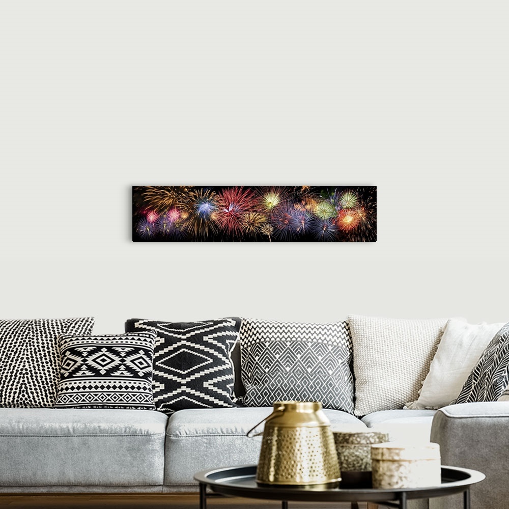 A bohemian room featuring Colorful panoramic view of fireworks over night sky.