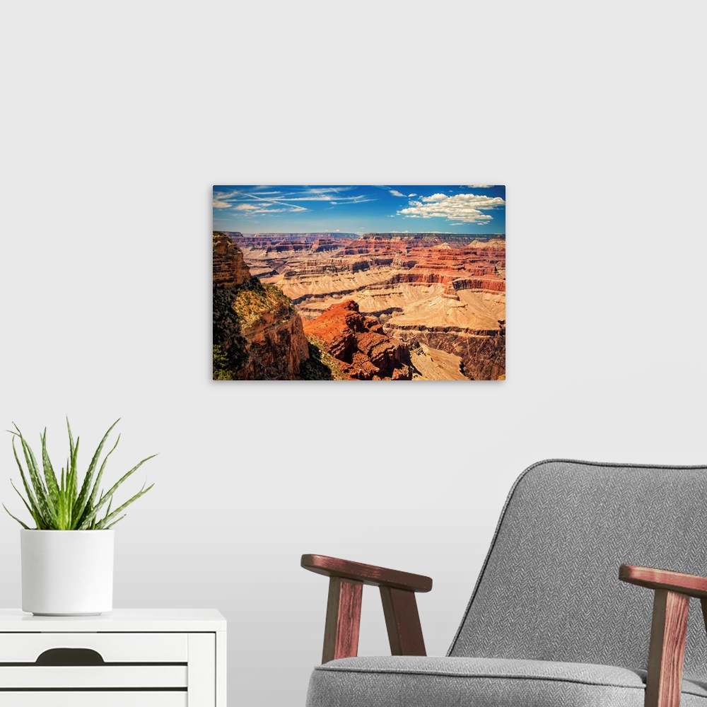 A modern room featuring Grand Canyon on a sunny day with blue sky.
