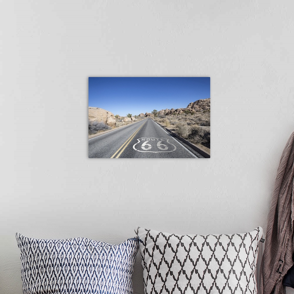 A bohemian room featuring Joshua tree highway with route 66 pavement sign in Californiaos Mojave desert.