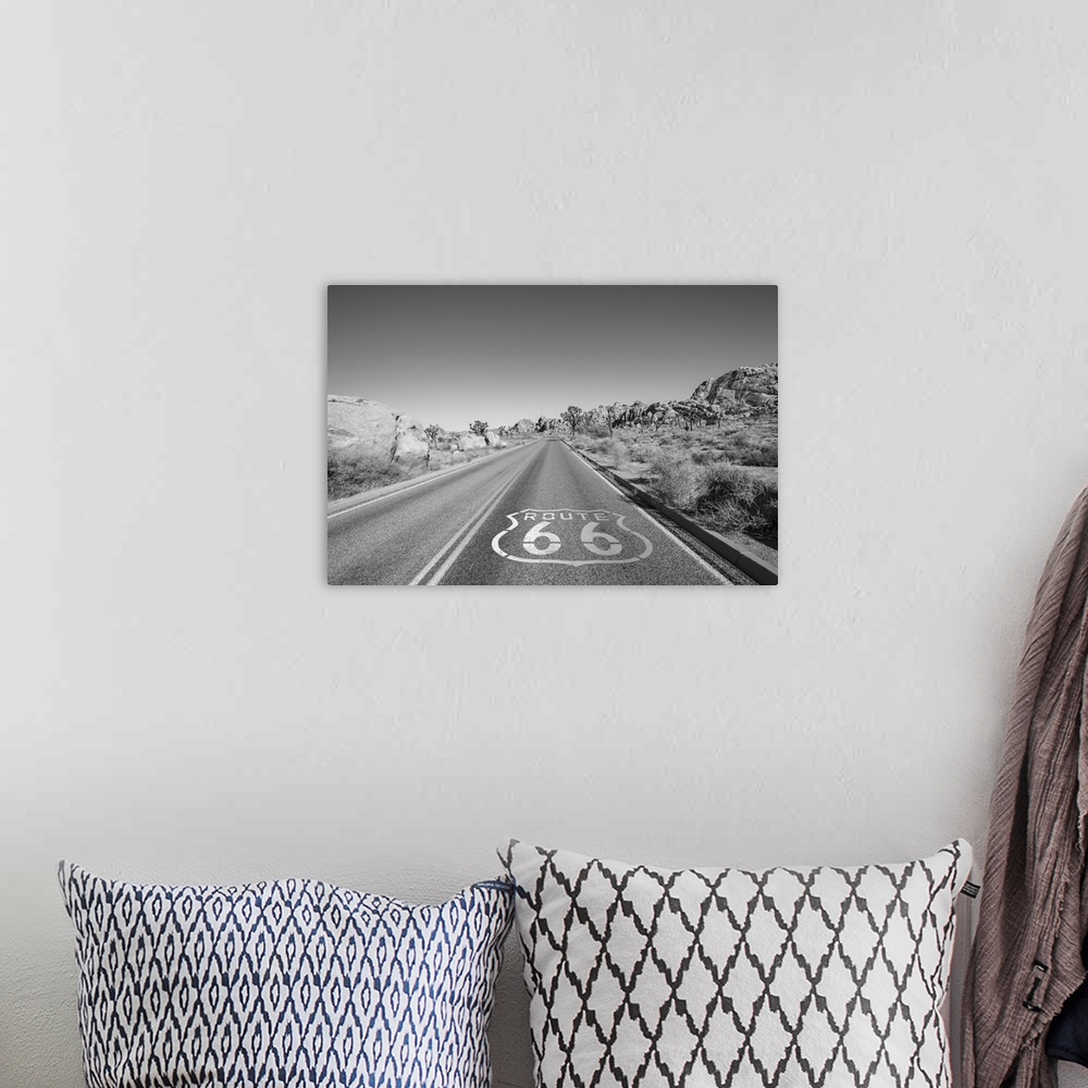 A bohemian room featuring Joshua tree highway with route 66 pavement sign in black and white.