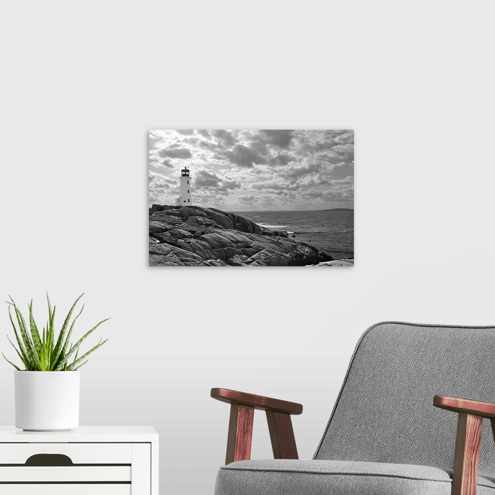 A modern room featuring Lighthouse at Peggy's Cove, Nova Scotia in black and white with dramatic clouds in sky.