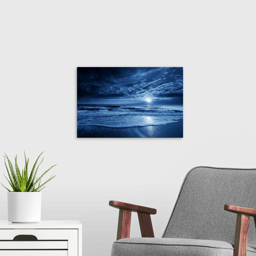 A modern room featuring This is a photographic illustration of a beautiful midnight-blue ocean moonrise with dramatic sky...