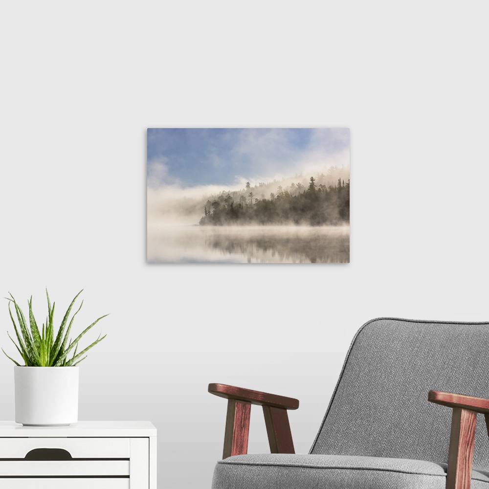 A modern room featuring Fog clearing on Ottertrack lake in the boundary waters.