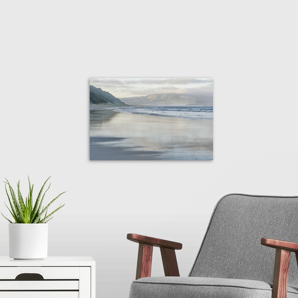 A modern room featuring Early morning fog, green hillsides and ocean waves on Oregon coast.