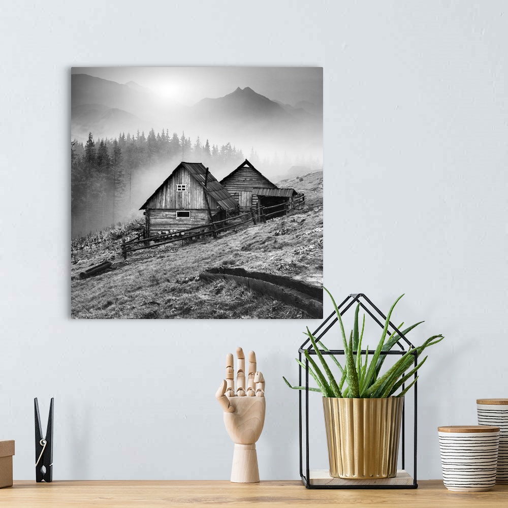 A bohemian room featuring Beautiful sunrise in Carpathian mountains with nature wooden houses on a forest hill. Black and w...