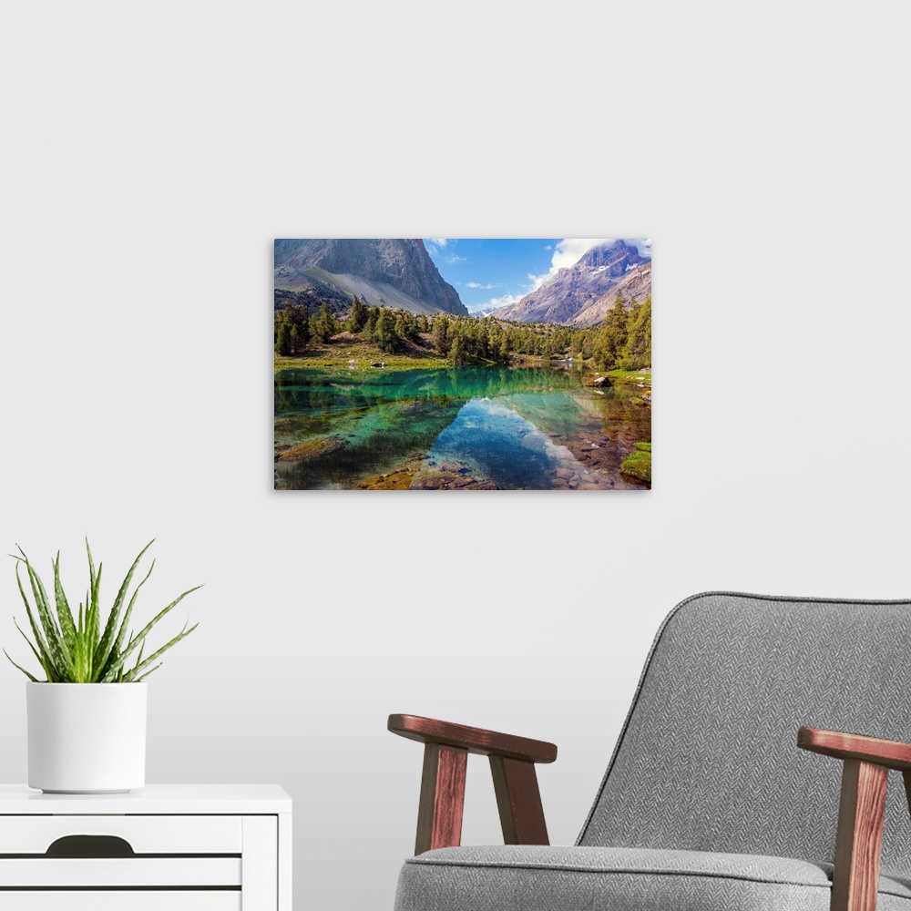 A modern room featuring Scenic landscape with vibrant water surface forest and high mountain peak blue sky.