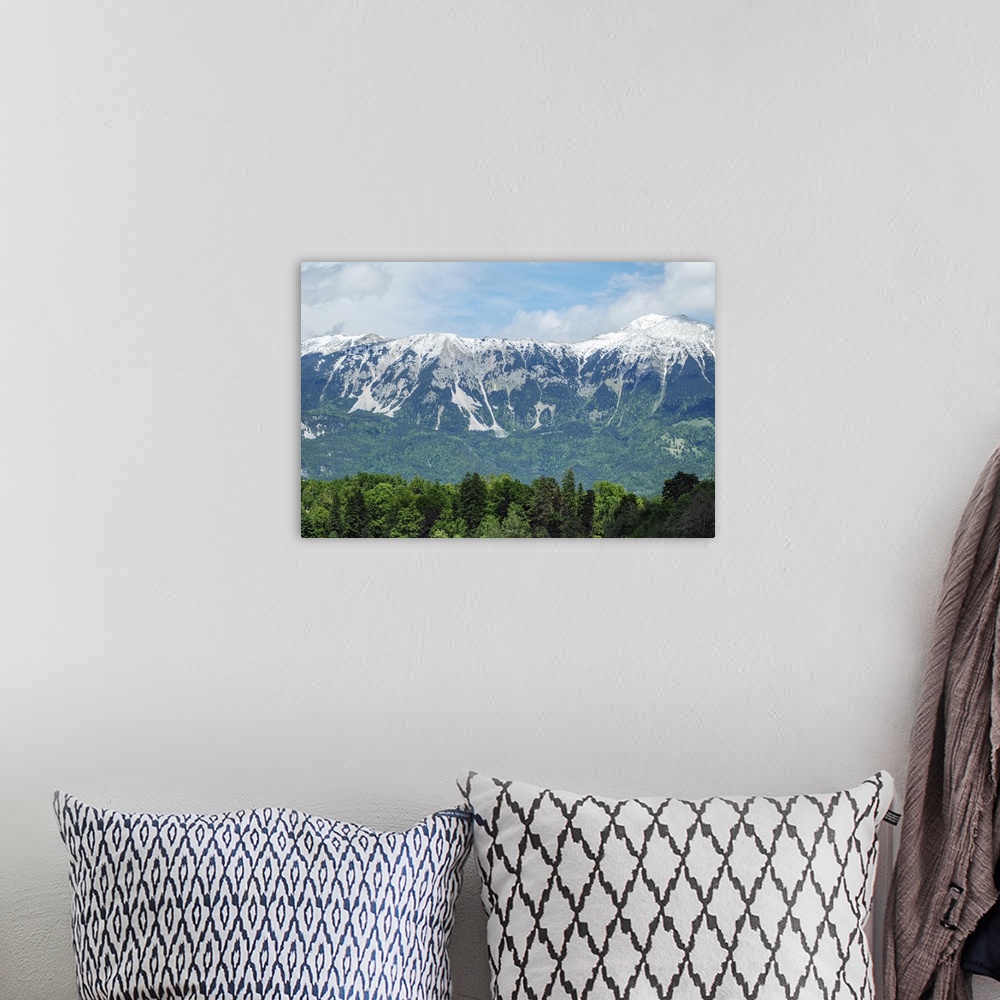 A bohemian room featuring Mountains landscape with blue sky and snow.