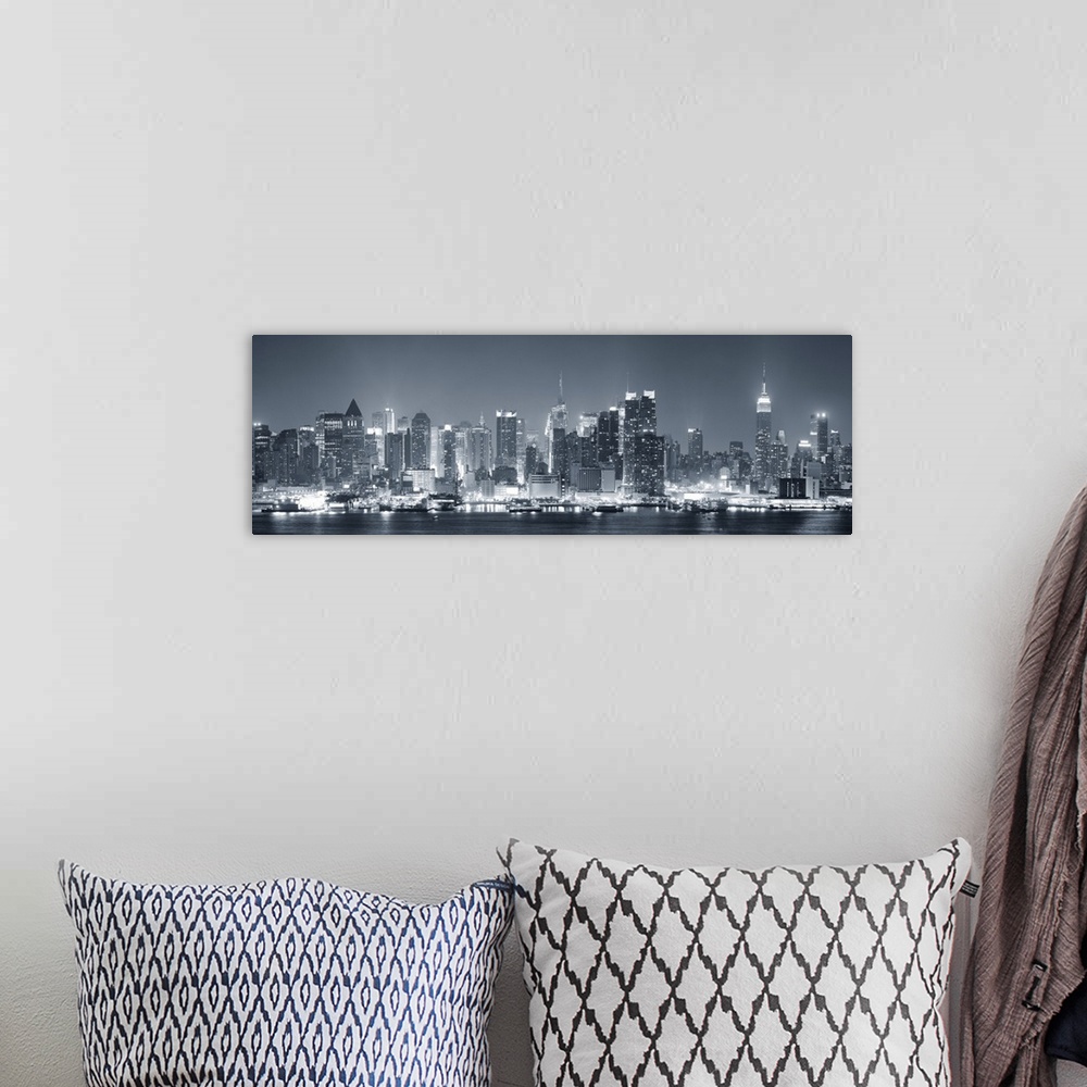 A bohemian room featuring Manhattan midtown skyline in black and white at night with skyscrapers lit over Hudson River with...