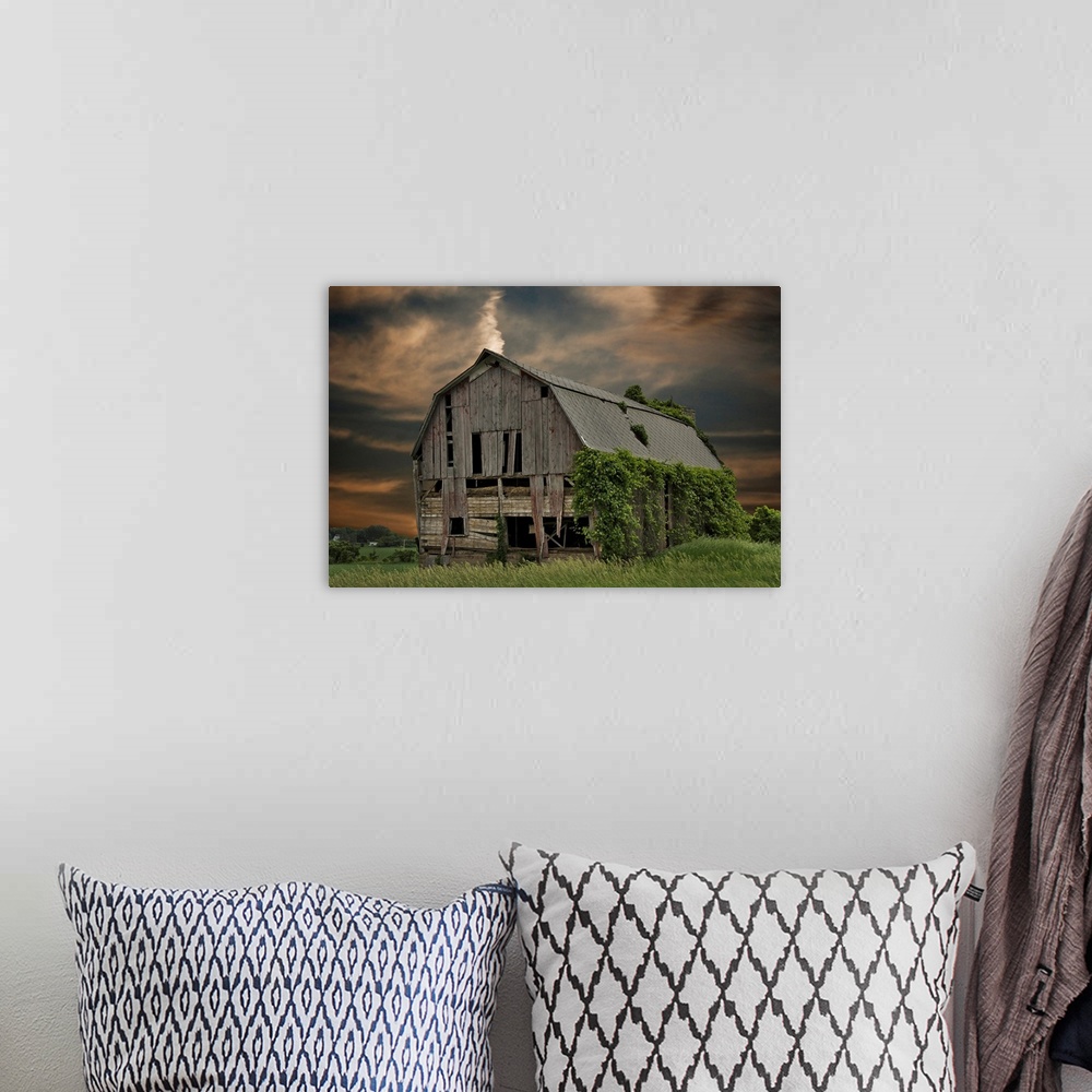 A bohemian room featuring Dilapidated old barn with sunset sky.