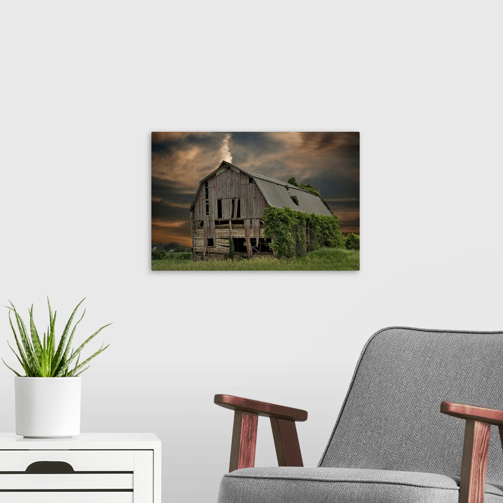 A modern room featuring Dilapidated old barn with sunset sky.