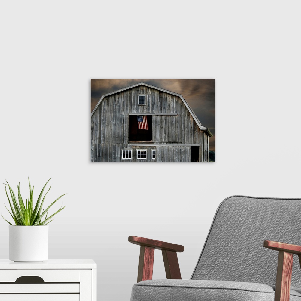 A modern room featuring Flag flying in hay loft of old barn.
