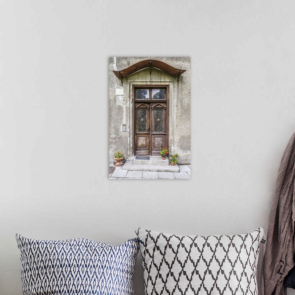 A bohemian room featuring Old door in an ancient European stone house.