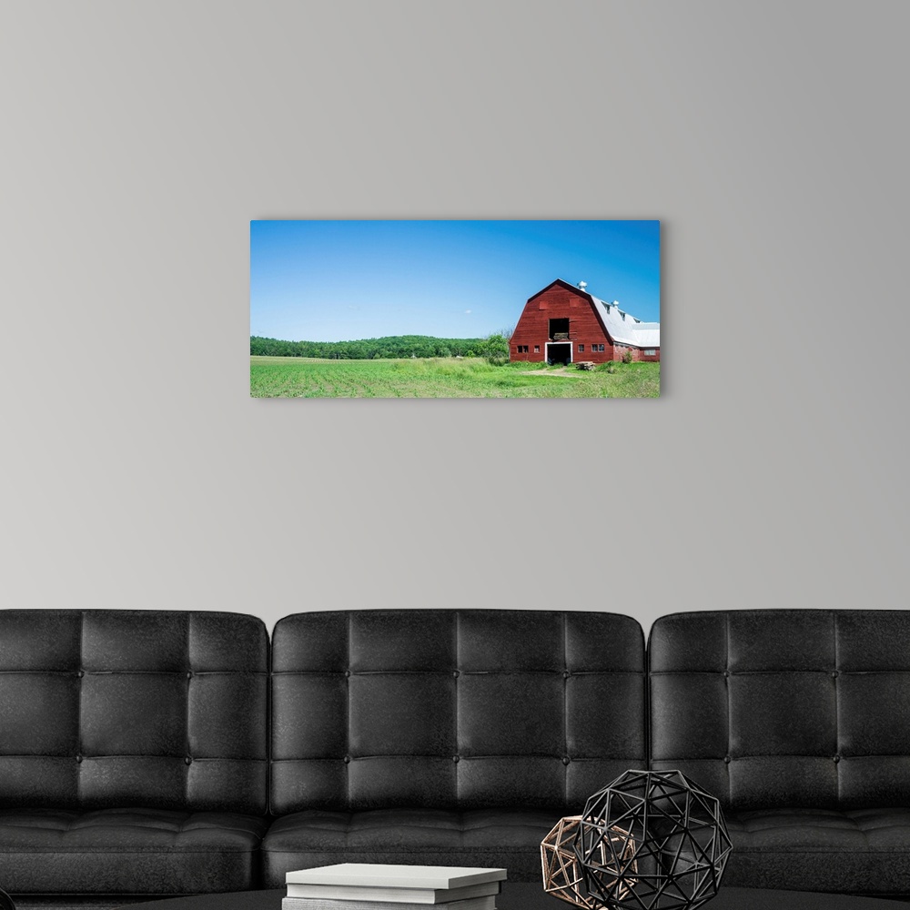 A modern room featuring A red barn, green fields, and blue sky of a classic Vermont family farm.