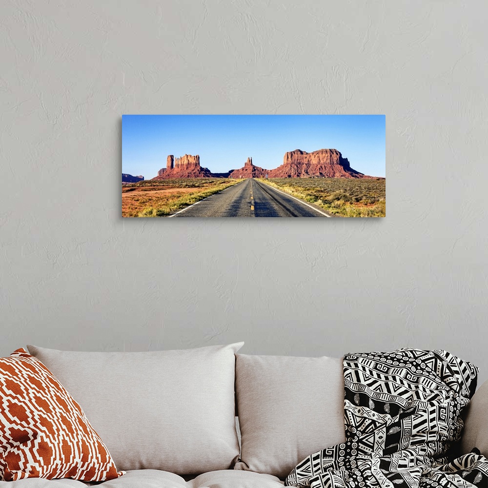 A bohemian room featuring Panoramic view of long road at monument valley, USA.