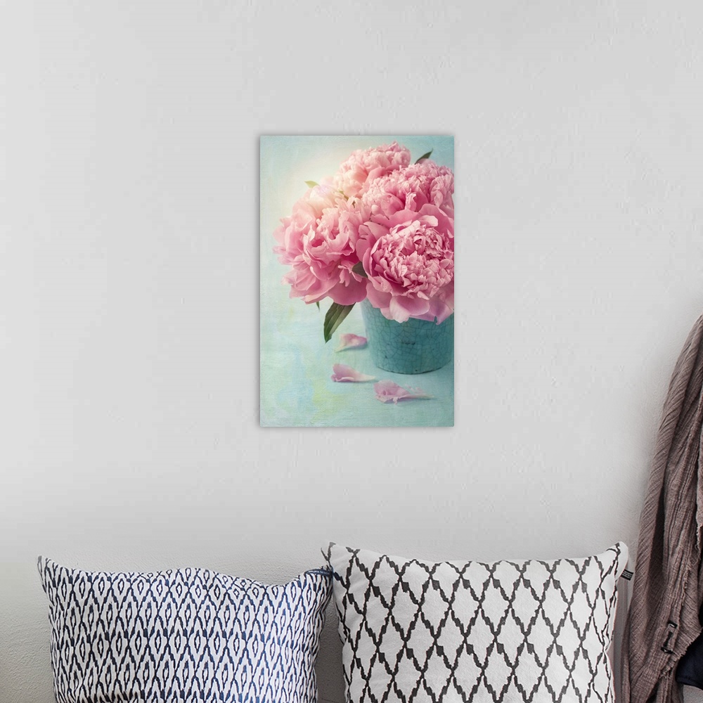 A bohemian room featuring Peony flowers in a vase.