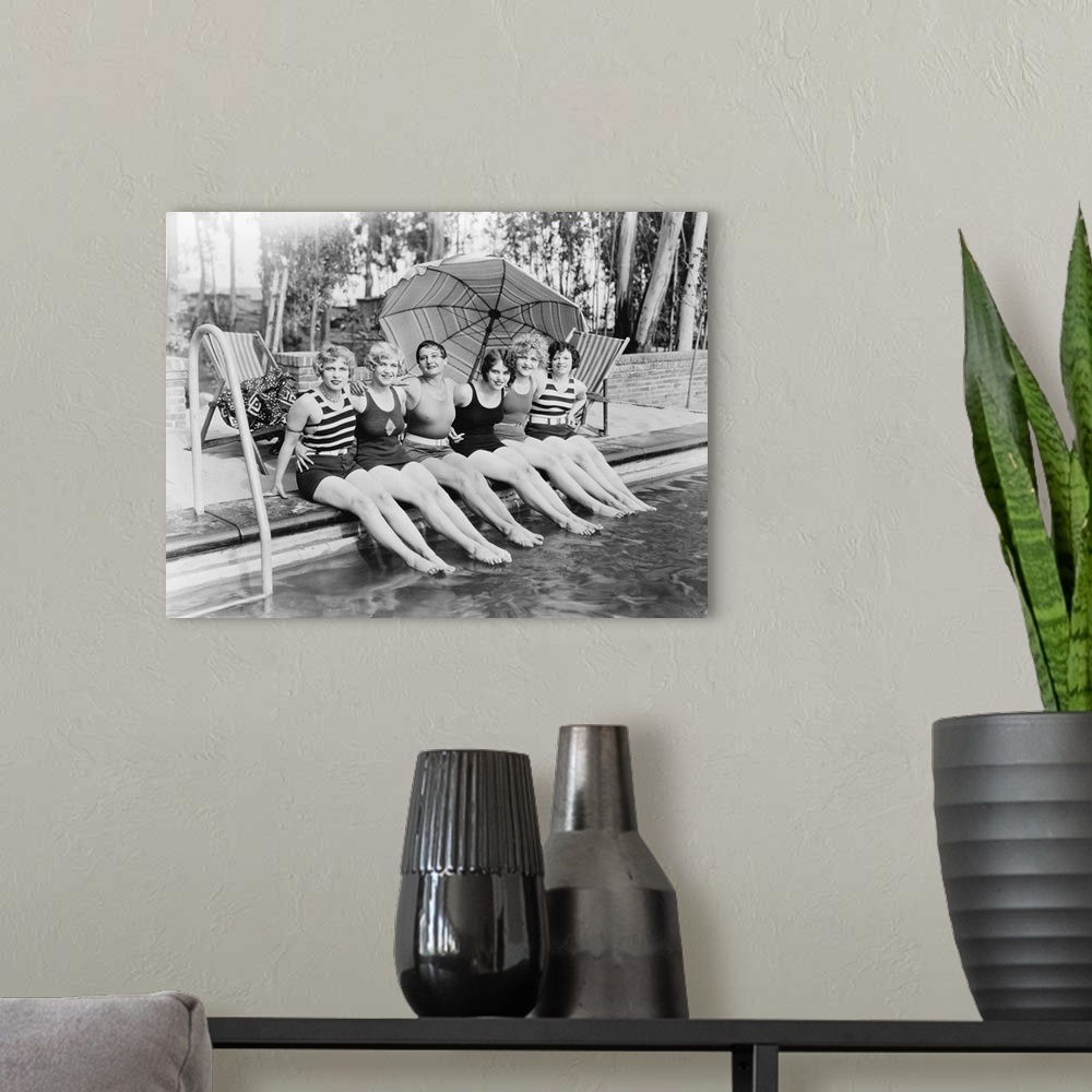 A modern room featuring Vintage portrait of female friends at a pool.