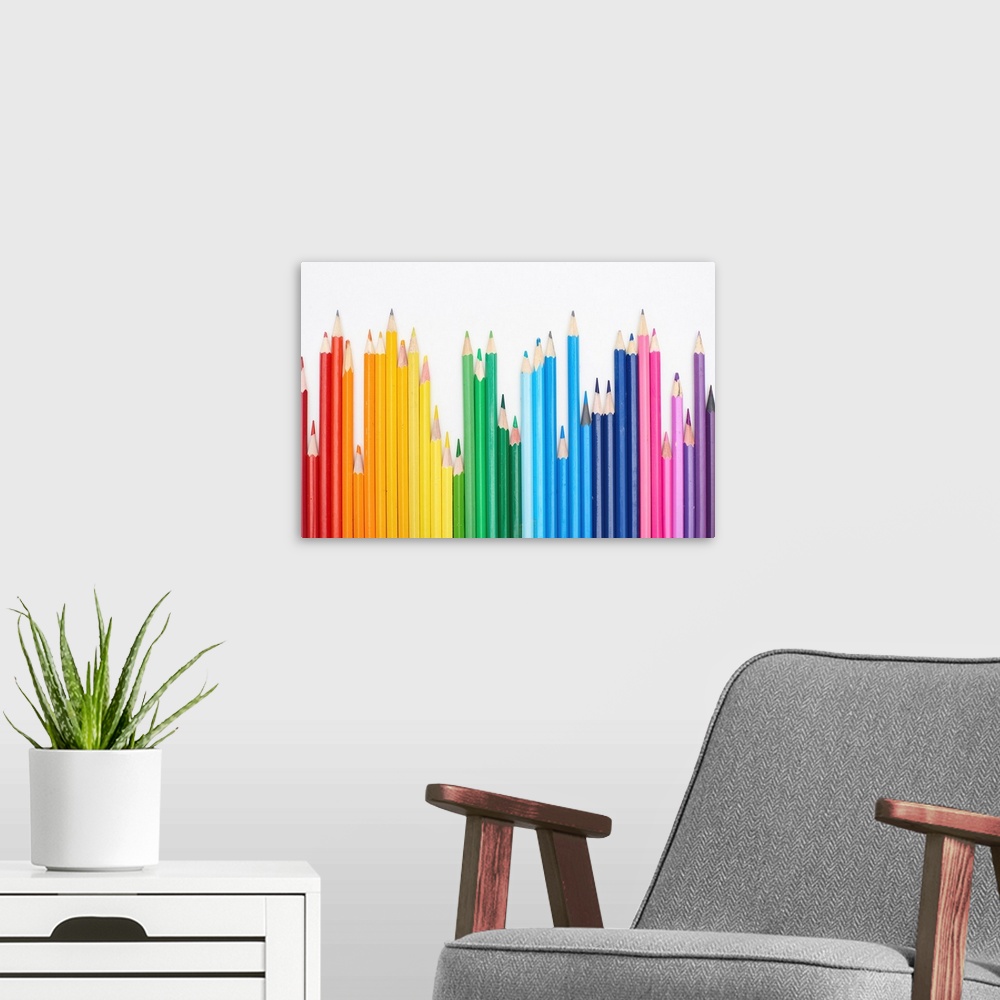 A modern room featuring Rainbow spectrum made with color pencils isolated on white.