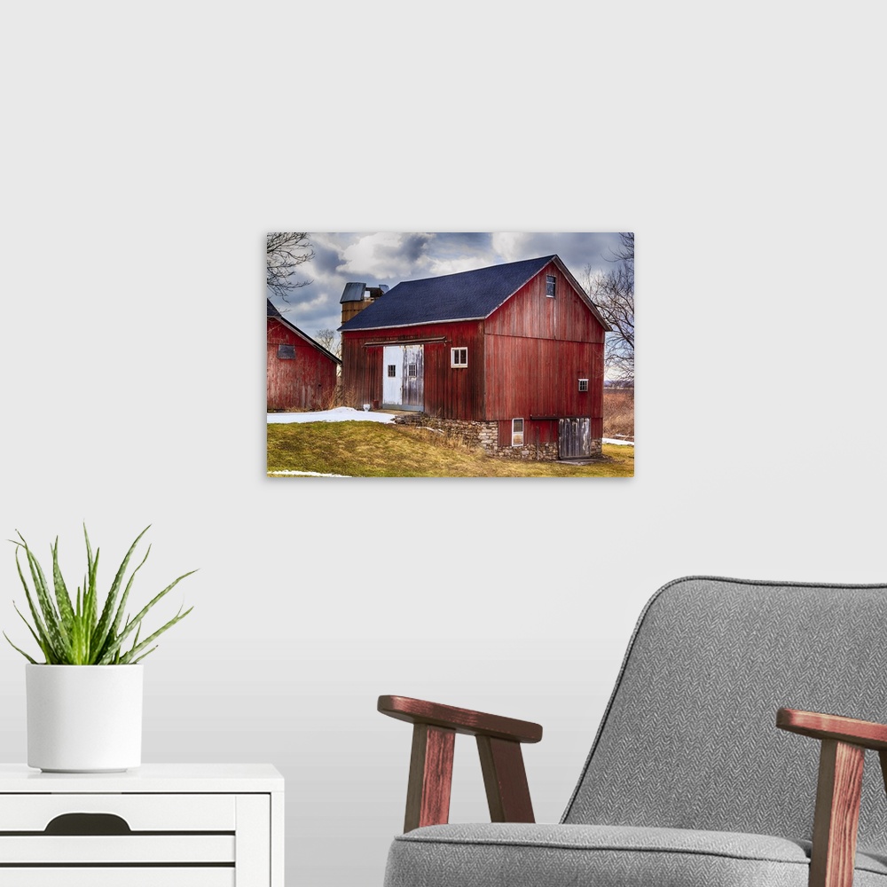 A modern room featuring Large red bank barn. New roof. Crisp colors and overcast sky.
