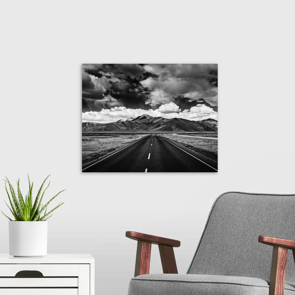 A modern room featuring Travel forward concept background - road on plains in Himalayas with mountains and dramatic cloud...