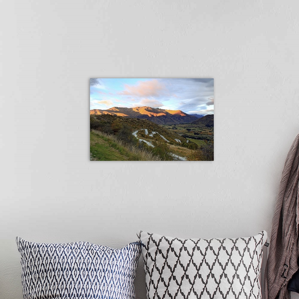 A bohemian room featuring Highway to Arrow Town with sunrise and mountain landscape in New Zealand.