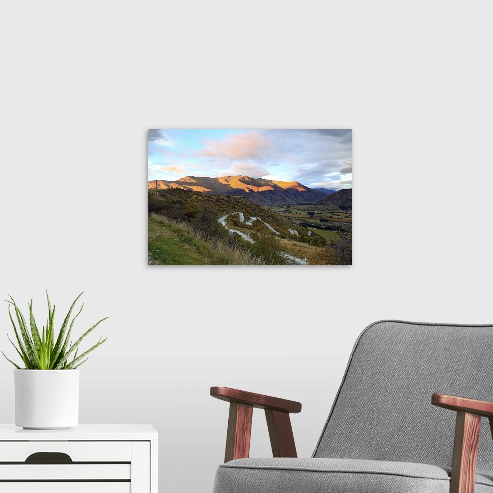 A modern room featuring Highway to Arrow Town with sunrise and mountain landscape in New Zealand.