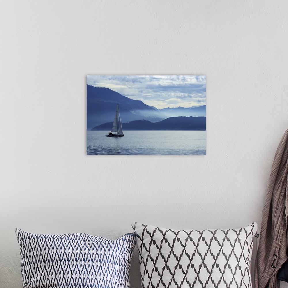 A bohemian room featuring Sailing on Lake Zug in Switzerland with the Alps in the background.