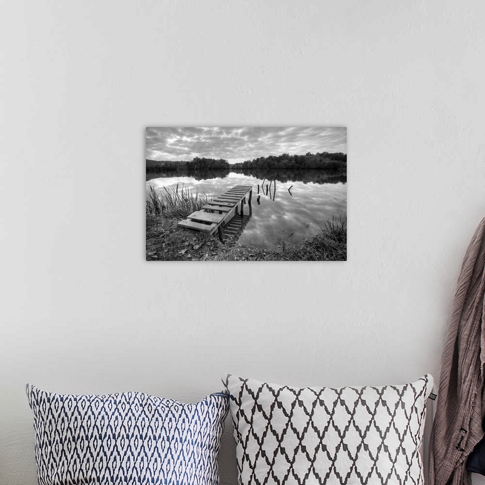 A bohemian room featuring Beautiful lake with pier on cloudy day in black and white.