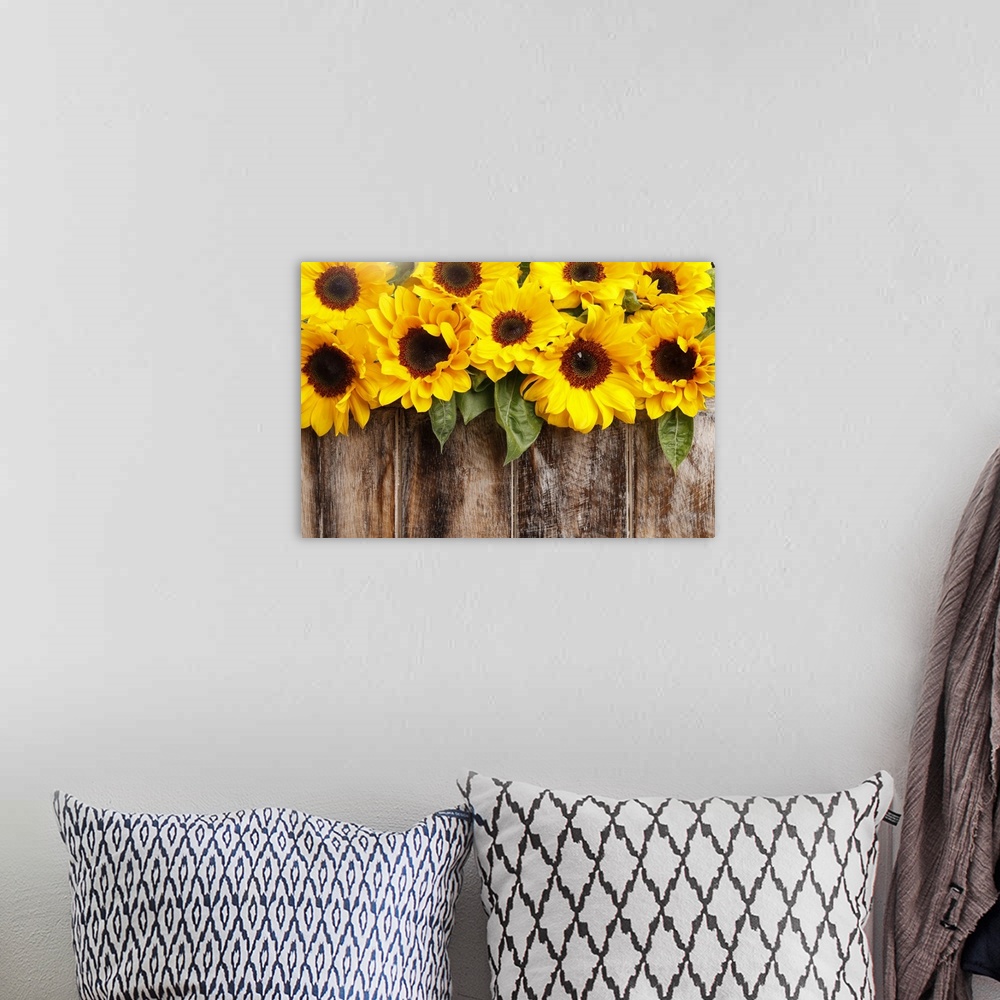 A bohemian room featuring Sunflowers on wooden background.