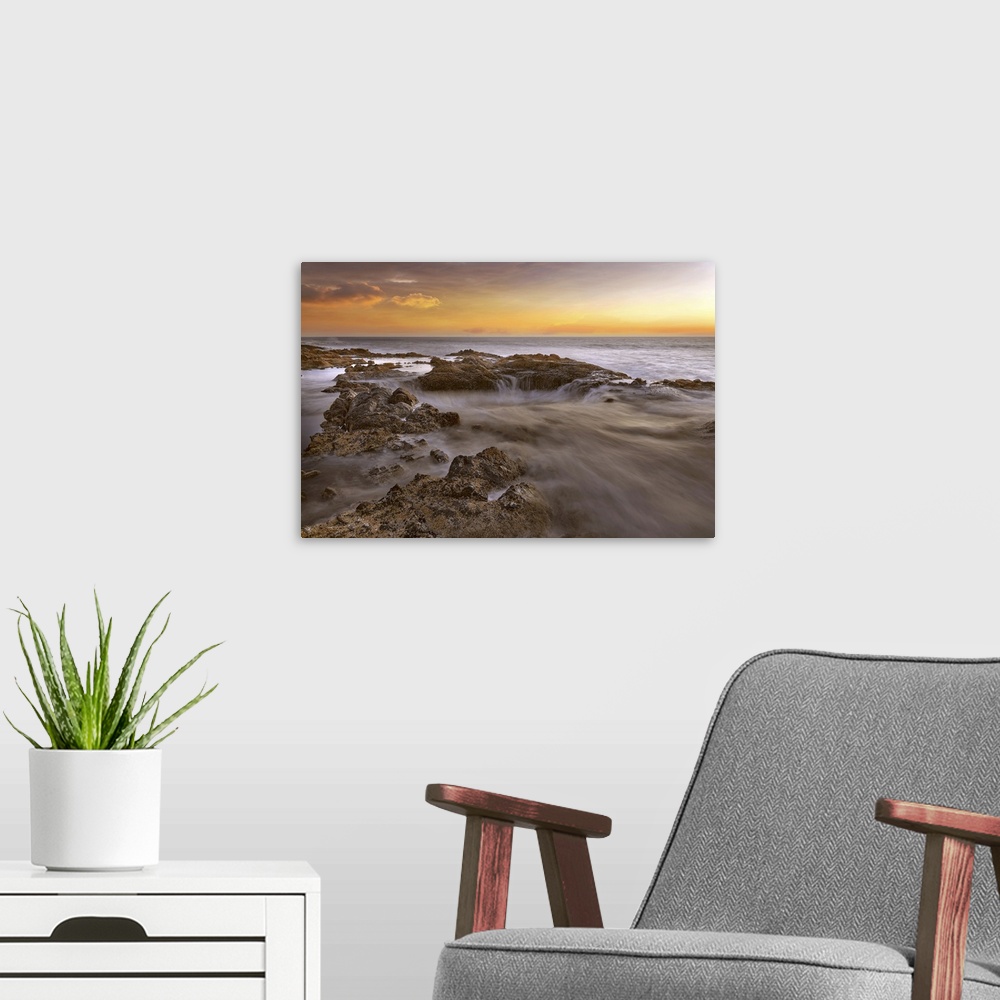 A modern room featuring Thors well at Cooks chasm by Cape Perpetua on the Oregon coast during colorful sunset.