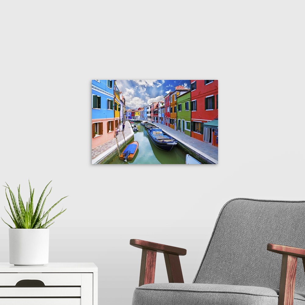 A modern room featuring Venice, Burano Island Canal. Small colored houses and the boats.